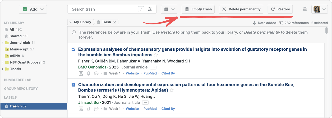 The Trash view holding 282 references with two ticked, and a red arrow pointing to the “Empty Trash”, “Delete permanently” and Restore buttons in the toolbar, above a note explaining each action.